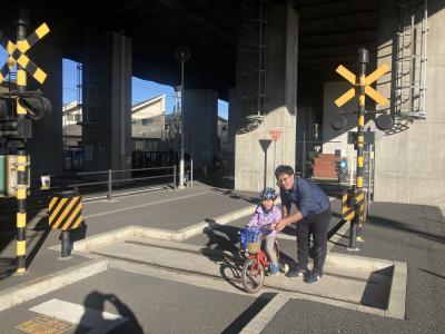 踏切で自転車練習する親子